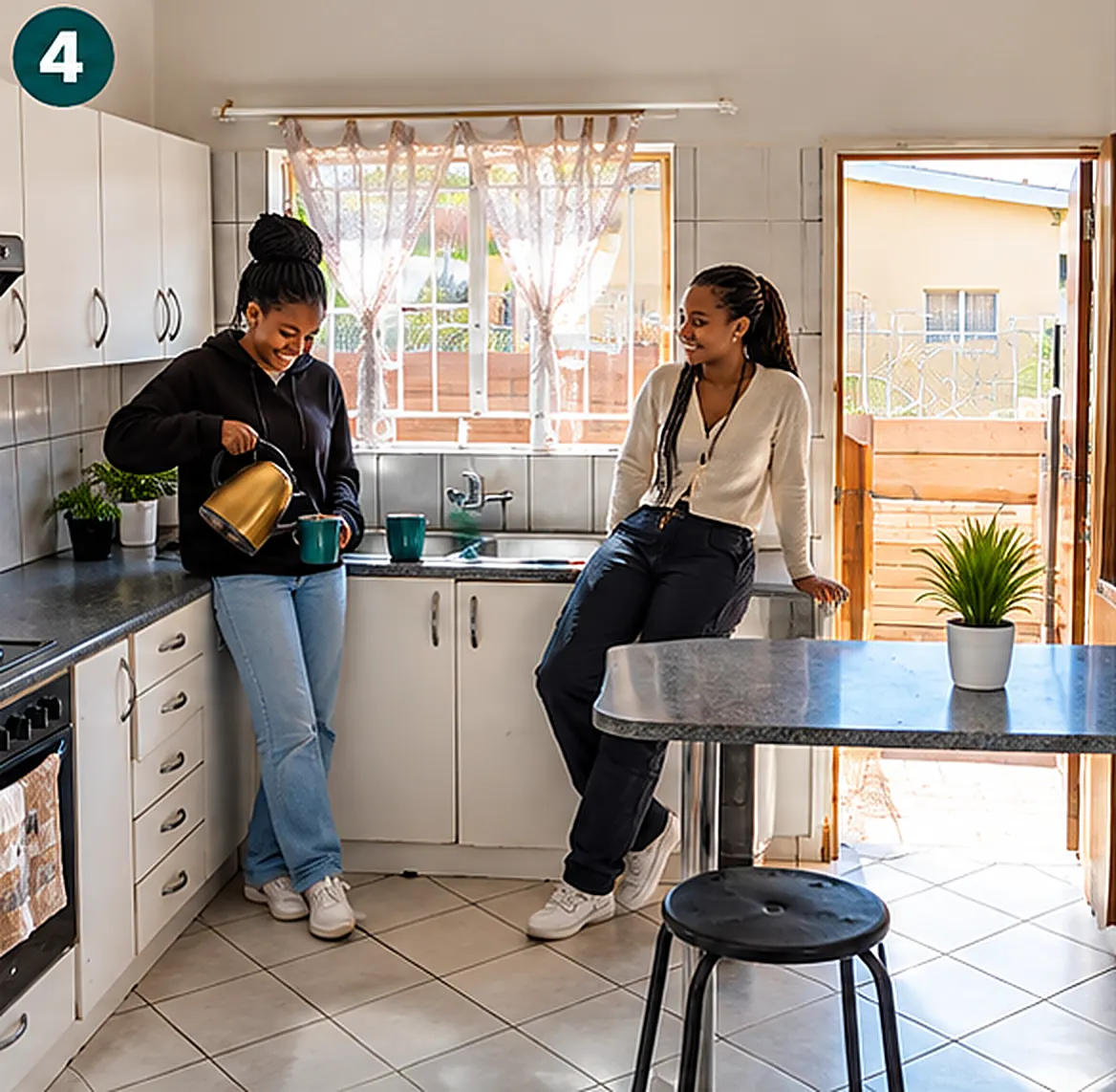 Two residents preparing coffee in the shared C4 kitchen